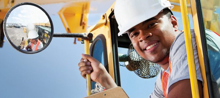 African American crane operator African American man, 20s, on crane at manufacturing facility.